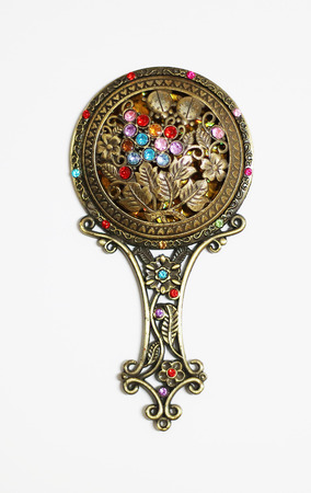 A Beautiful ancient hand mirror with ancient colorful stones.の写真素材