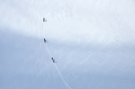 A group of skiers wandering across a glacier in Austrian Alpsの写真素材