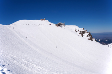 Ski area, run and pistes, chairlift, cable car station and the astronomical, meteorological observatory at the summit of Kasprowy Wierch and Hala Gasienicowa in Tatra Mountains in Polandの写真素材