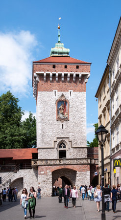 KRAKOW, POLAND - MAY 30, 2015: Gothic St Florian's Gate (Brama Florianska) in Cracow, Poland and walking peopleのeditorial素材