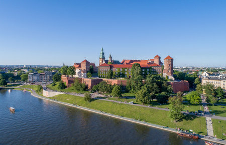 Historic royal Wawel castle in Cracow, Poland with park and Vistula river. Aerial view at sunset.のeditorial素材