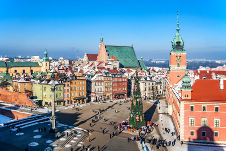 WARSZAWA, POLAND ? JANUARY 23, 2016: Warsaw old town in winter with Plac Zamkowy (Castle Square), Christmas tree with gifts, Cathedral, Royal Castle, Sigismund?s Column and walking peopleのeditorial素材