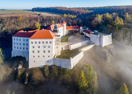 Historic castle Pieskowa Skala near Krakow in Poland. Aerial view in fall at sunrise in morning fog.のeditorial素材