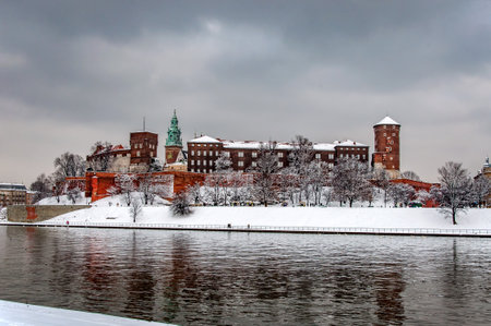 Historic royal Wawel Castle iand Cathedral n Cracow, Poland, with Vistula river on a cloudy day in winter.のeditorial素材