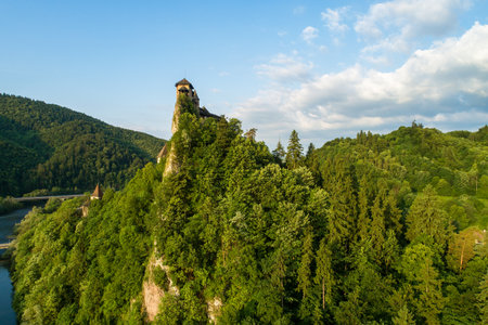 Orava castle - Oravsky Hrad in Oravsky Podzamok in Slovakia. Medieval stronghold on extremely high and steep cliff by the Orava river. Aerial view in sunrise light in summerのeditorial素材