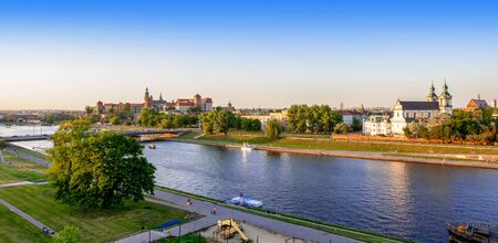 Krakow, Poland. Aerial panorama with Wawel cathedral and castle, Skalka church, Paulinite monastery, Vistula river, bridge, playground, parks and promenades along the riverside. Summer, sunset lightの写真素材