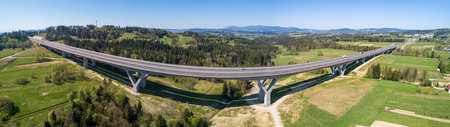 Wide aerial panorama of a new highway on national road no 7, E77, called Zakopianka, near Skomielna Biala village. Far view of Babia Gora mountain in the backgroundの写真素材