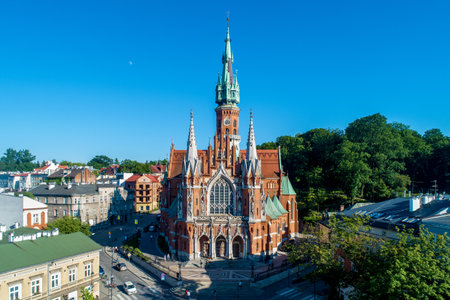 Krakow, Poland. Church Saint Joseph - a historic Roman Catholic church in Gothic Revival (neo-Gothic) style at the Podgorski Square in Podgorze district in Cracow in sunset light. Aerial view.のeditorial素材