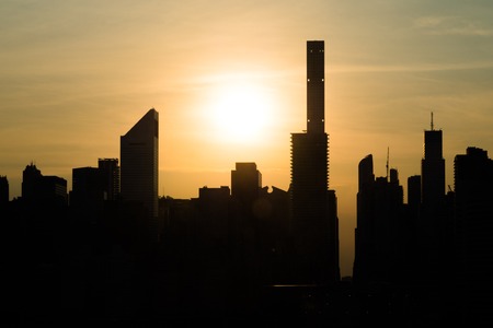 New York city silhouetted skyline against orange sunset. Skyscrappers.の写真素材