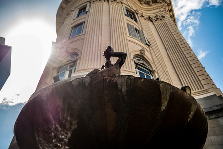 Statue of a man with horn looking up in a sunny day in Buenos Aires.の写真素材