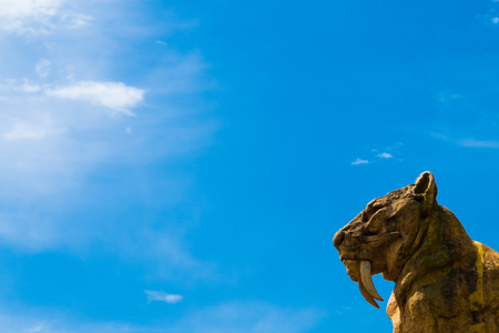 Sabertooth tiger statue in the lower right corner and an amazing blue sky in La Plata, Buenos Aires.の写真素材