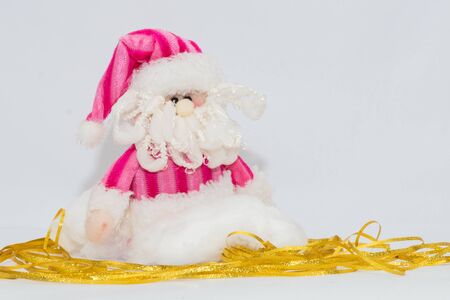 Adorable pink Santa Claus with gold floor and white background.の写真素材