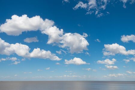 Beautiful blue sky with white clouds and Rio de La Plata horizonの写真素材
