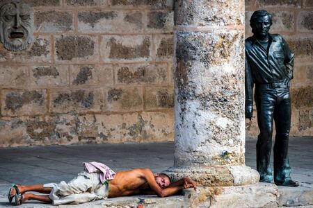 Poverty in Old Havana. Homeless man sleeping on the floor next tのeditorial素材