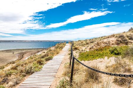 Bridge in Puerto Madryn beach, sun, waves and sand, beautiful day.の写真素材