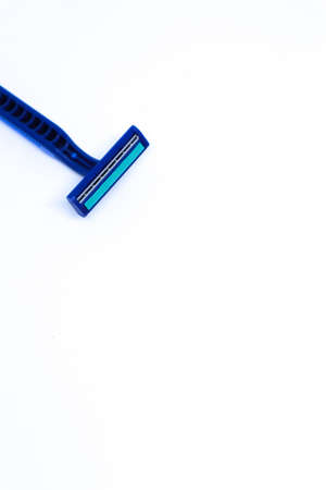 Flat Lay Shot of A Blue Razor in The Corner of Minimalist White Background, Portrait Modeの写真素材