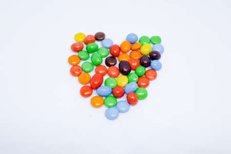 Colorful Candies with Love Shape in The White Background with Flat Lay Shotの写真素材
