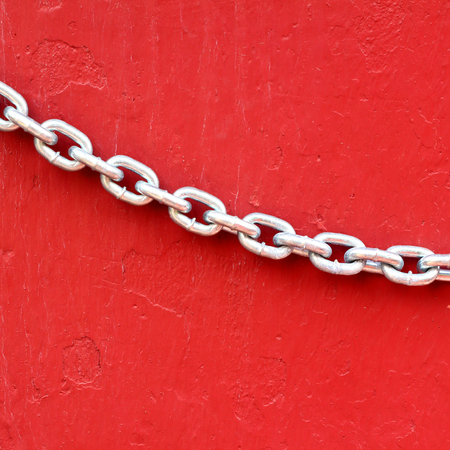 Closeup Chains on red wall background