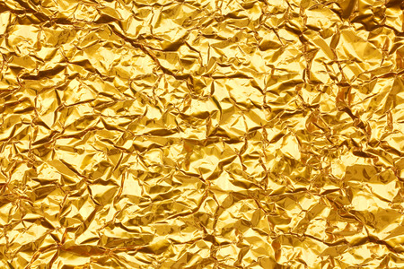 Shiny yellow leaf gold foil texture backgroundの写真素材