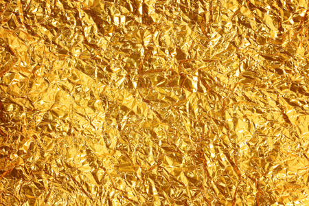 Shiny yellow leaf gold foil texture backgroundの写真素材