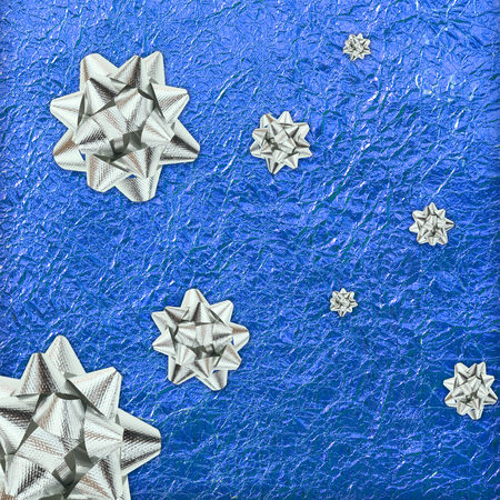 Shiny blue leaf gold and  silver ribbon on Shiny foil texture backgroundの写真素材