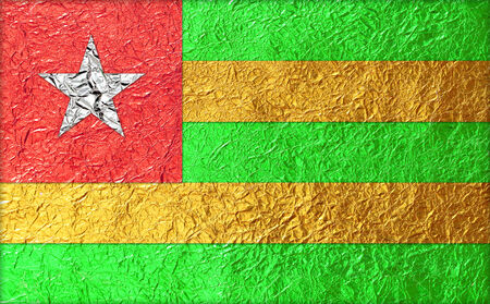 Togo Flag with a Shiny  leaf  Bronze Shiny  leaf   foil texture backgroundの写真素材