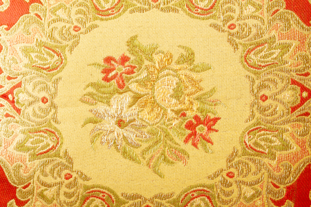 Fragment of colorful retro tapestry textile pattern with floral ornament useful as backgroundの写真素材