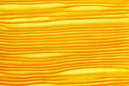 Gold creased fabric silk for backgroundの写真素材