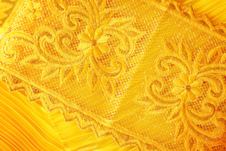 Gold peach lace sits on a gold backgroundの写真素材