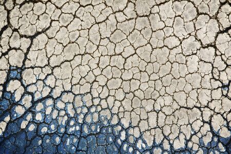 Texture of cracked plastic on corroded old shoe surface