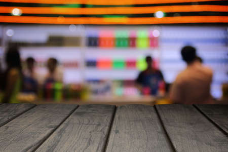 Perspective wood and blurred cafe with bokeh light background. product display template