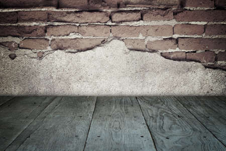 old perspective wooden floor and cracked brick wallの写真素材