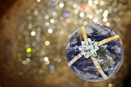 The earth tied with ribbon with bokeh background. Elements of this image furnished by NASA