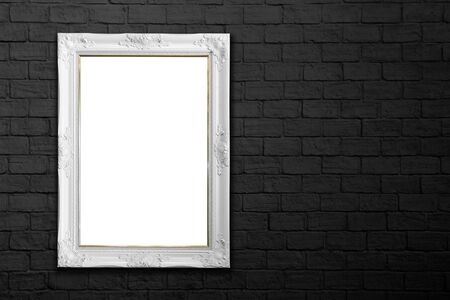 white frame on black brick wallの写真素材