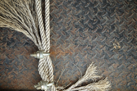 Old Ropes with U-Bolt Clamp on a rusty metal background