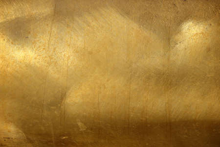 Shiny yellow leaf gold foil texture backgroundの写真素材