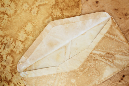 Old envelope on vintage aged old paper