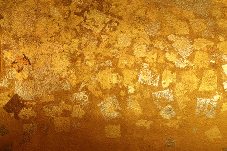 Old gold grunge wall with peeling paint with old concreteの写真素材