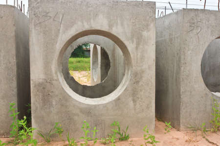 Concrete drainage tube and manhole on construction siteの写真素材
