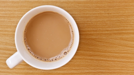 White cup of hot coffee on wood tableの写真素材