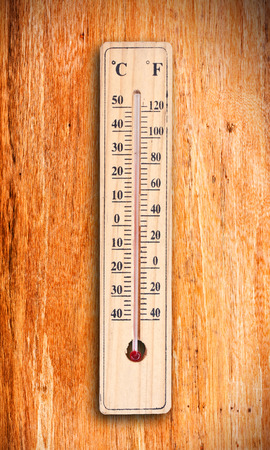 Thermometer on wood background