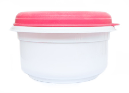 Empty food plastic container with pink lid isolated on whiteの写真素材