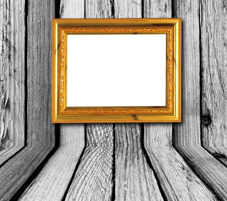 gold picture frame on wood background