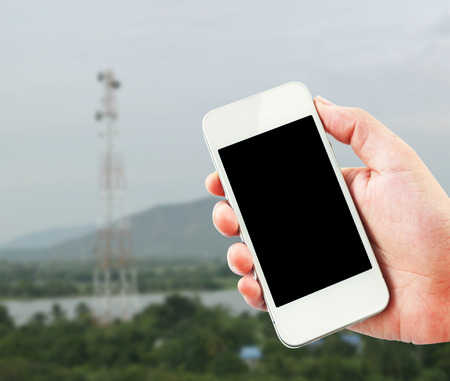woman hands hold smart phone in countryside.