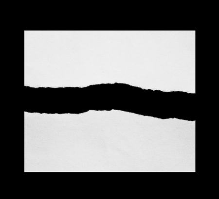 Piece of torn paper on blackの写真素材