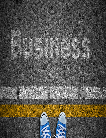 Focus of shoes standing on a road with business conceptの写真素材