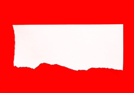 White paper torn on a red background.の写真素材