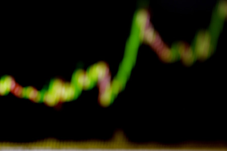 Stock exchange trade chart bar candles macro close-up. Shallow depth of field effect. Screen shows stock price rates live. Display of Stock market quotes. Background with stock diagram on monitor.の写真素材