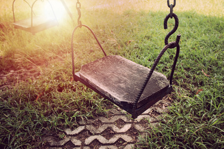 Empty swing in playground. Vintage filter.の写真素材