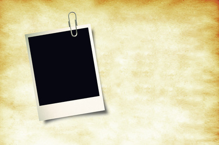 close up of a old photo instant film on old paper background.の写真素材